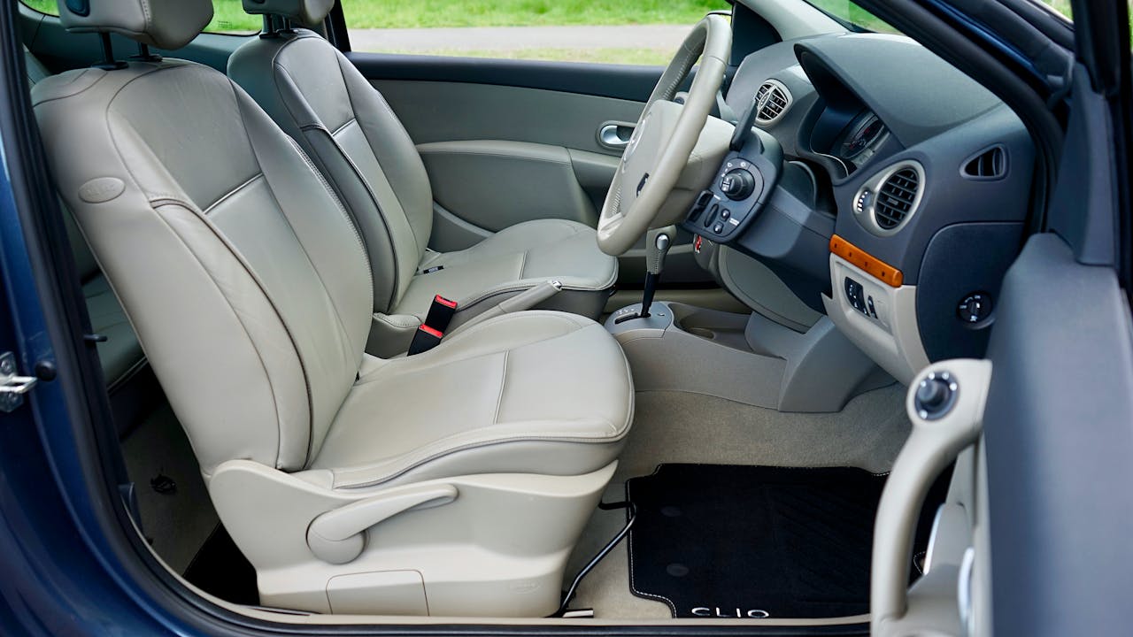 Explore the sleek interior of a Renault Clio, highlighting luxury car features and design.
